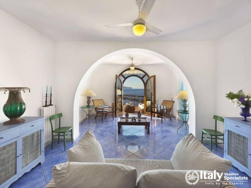 Cozy living room with a scenic view through arched doorways.