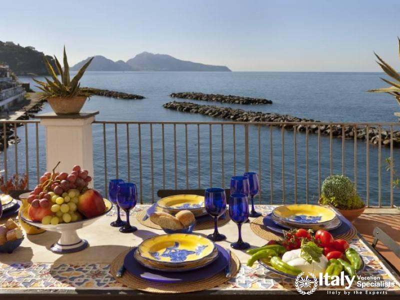 Elegant outdoor dining setup with a breathtaking sea view. \