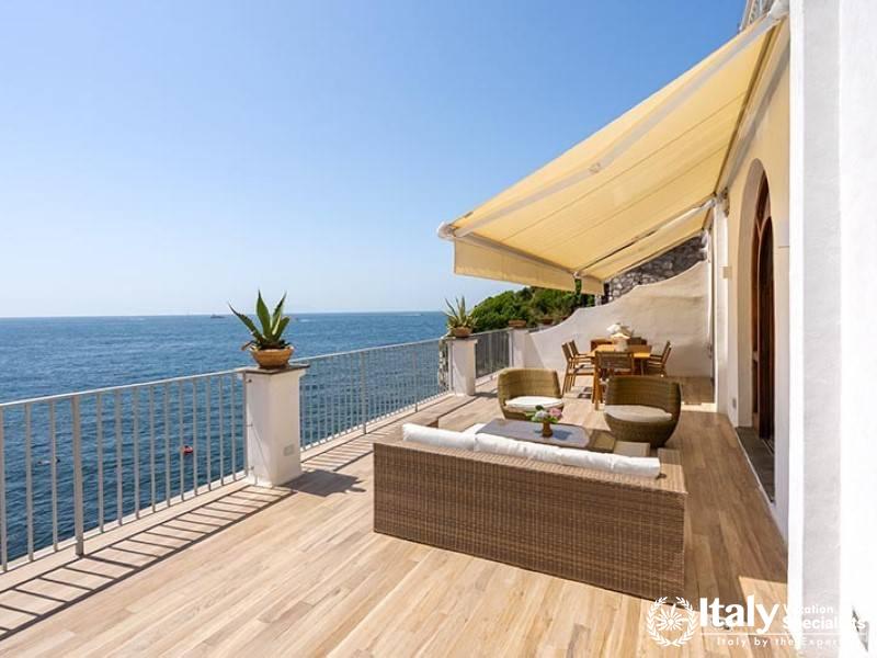 Comfortable outdoor seating area with oceanfront view.