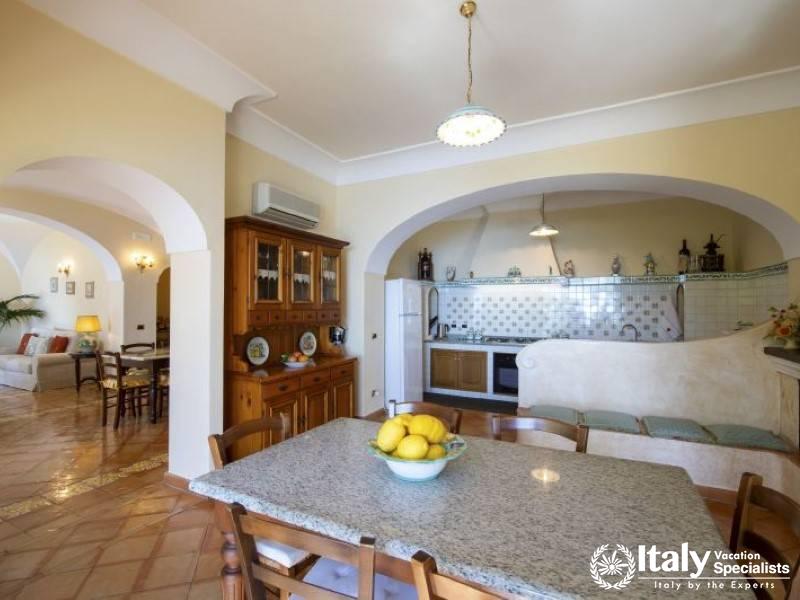 A charming kitchen and dining area with classic Mediterranean decor and natural light.