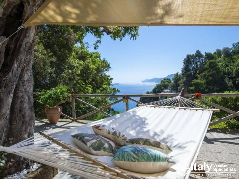 A cozy hammock under the shade, offering ultimate relaxation with panoramic ocean vistas.