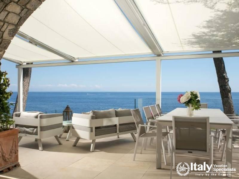 Spacious outdoor seating and dining area with ocean views.