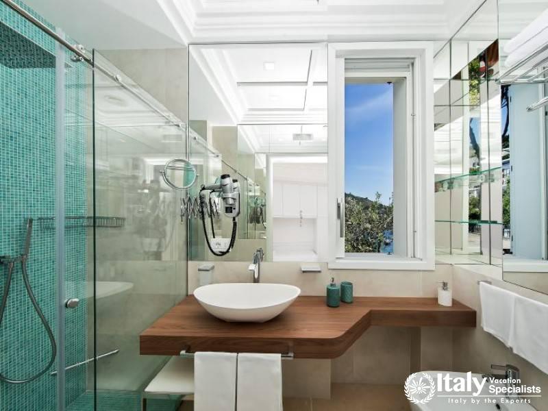 Elegant bathroom with a glass shower and a scenic window view.