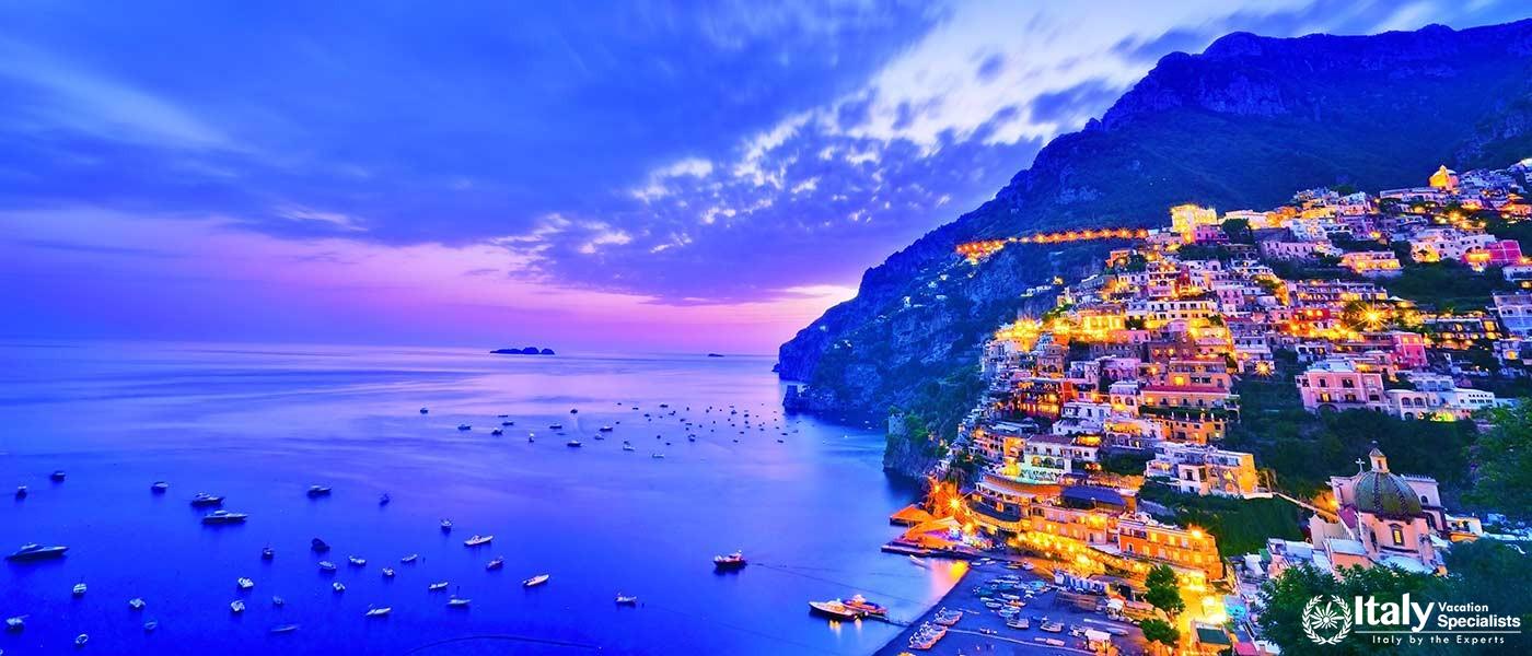View of Positano village along Amalfi Coast in Italy at dusk
