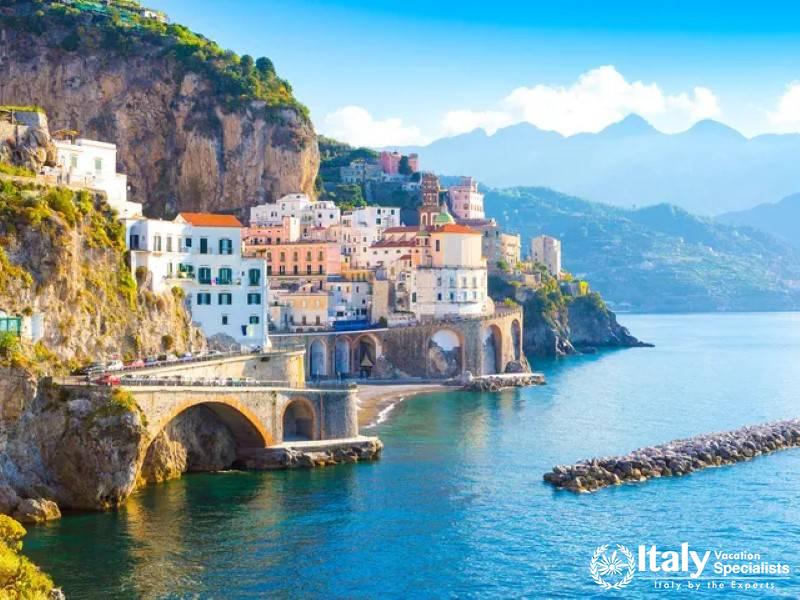 Atrani village elegantly draped along the coast beneath towering cliffs.