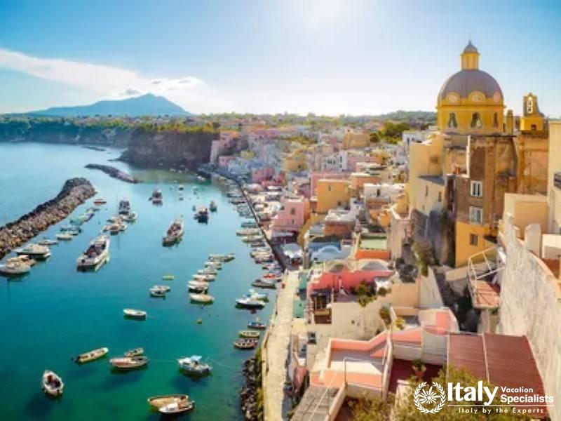 The charming harbor of Procida with colorful houses and boats.