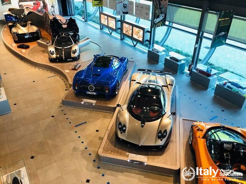 A showcase of luxury automotive craftsmanship at the Pagani Factory, featuring the iconic Zonda and 