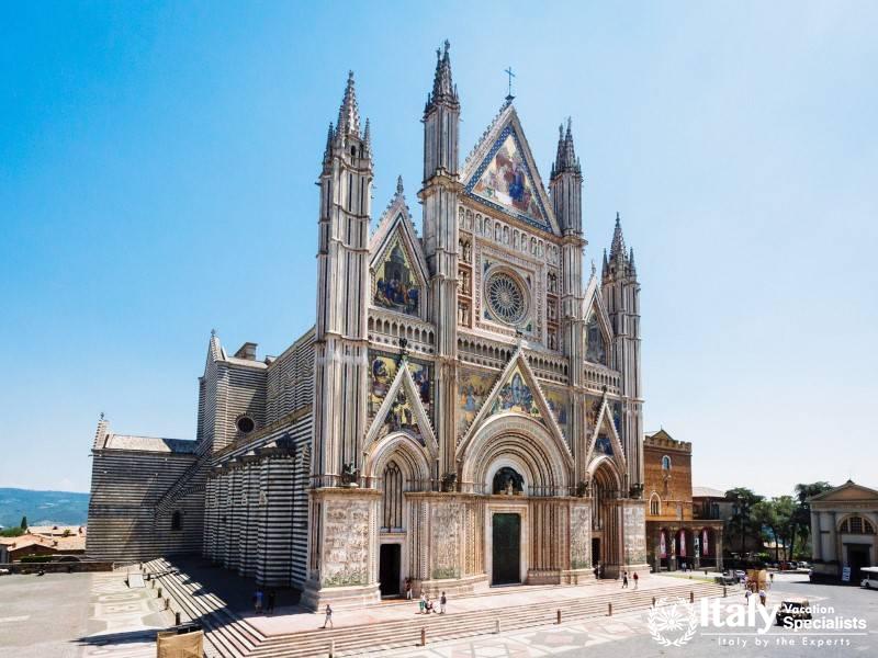 The striking facade of Orvieto Cathedral, known for its intricate Gothic architecture and colorful m