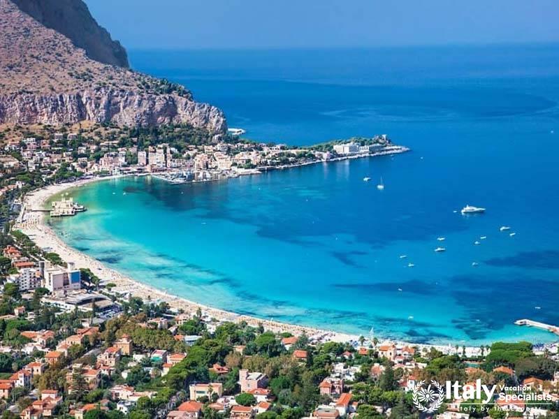 Beautiful coastal vista, highlighting the townâ€™s colorful houses, rocky hills, and the glistening 