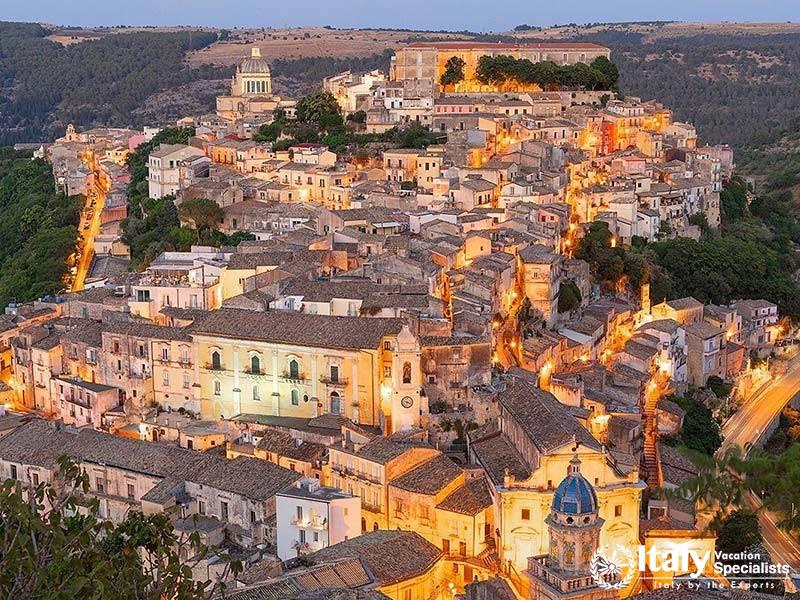 Captivating view of a historic hilltop village at twilight, showcasing beautiful architecture and wa