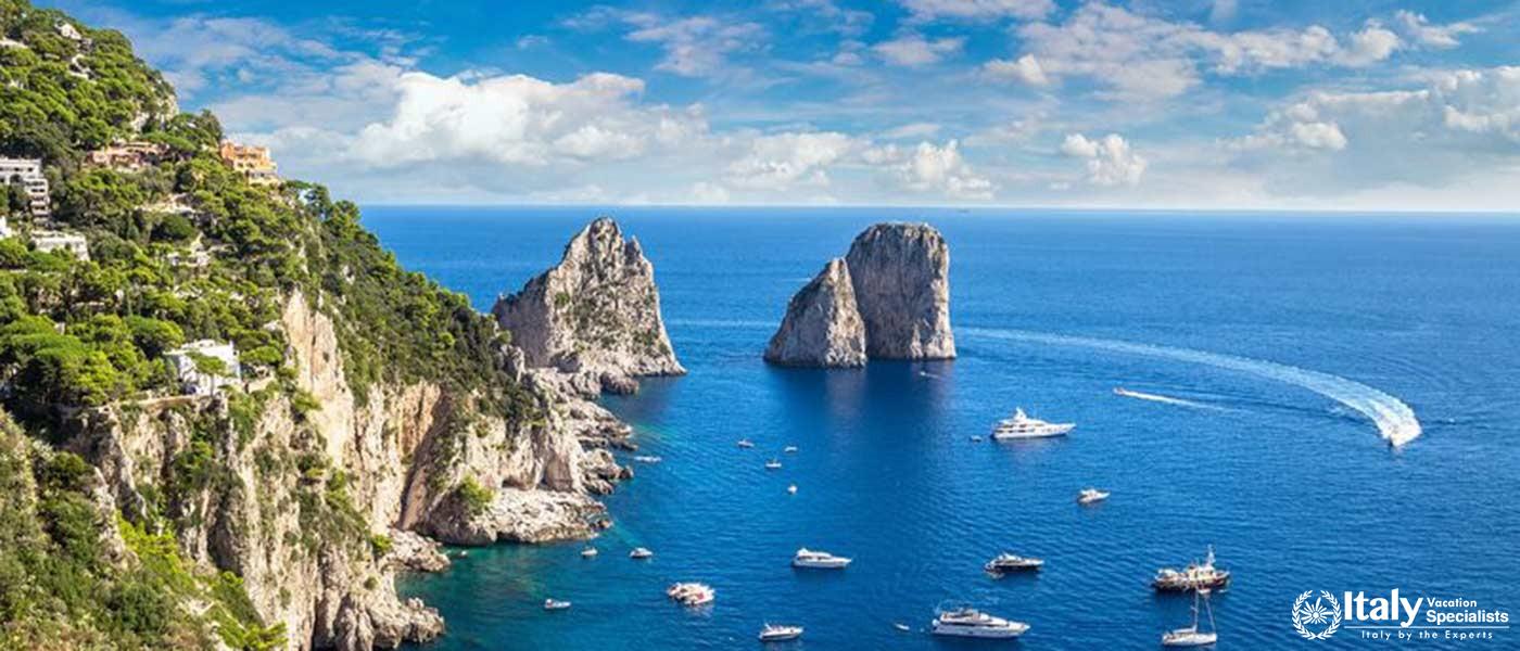 Capri's Iconic Faraglioni Rocks: Boats sailing around the famous Faraglioni rocks in Capri.