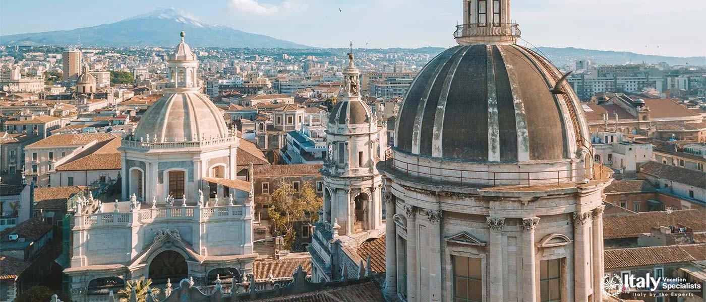 Catania city with the stunning backdrop of Mount Etna, with its volcanic peaks rising above the skyl