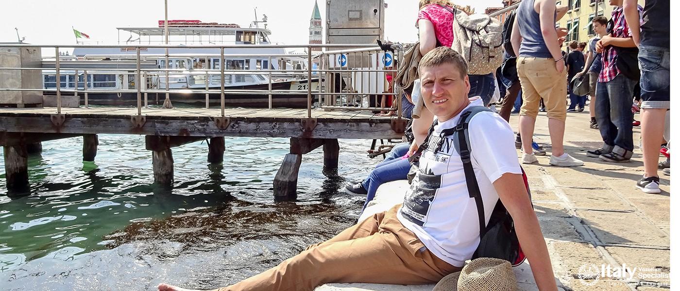 Venice, Italy - July, 2014 People sitting on the embankment of Grand Canal in Venice, Italy, relaxin
