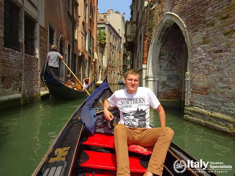 Venice, Italy - July, 2014 Tourists travel on gondolas at canal Venice, Italy. City in northeastern 