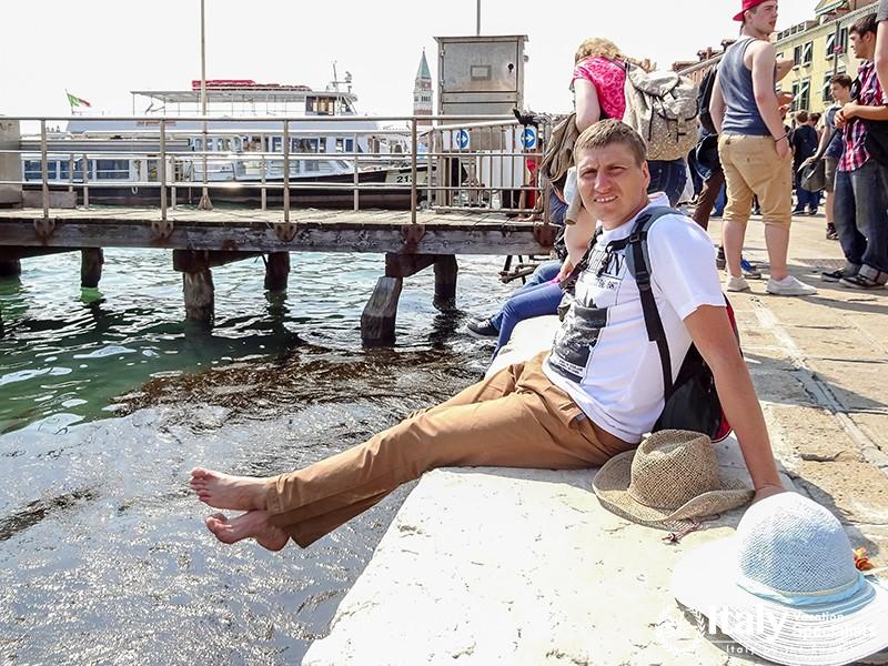 Venice, Italy - July, 2014 People sitting on the embankment of Grand Canal in Venice, Italy, relaxin
